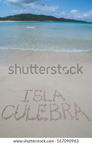 The letters ISLA CULEBRA carved in soft white sand of beautiful Flamenco Beach on tropical Puerto Rican island