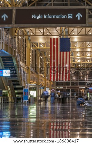 ARLINGTON, USA - OCTOBER 2, 2014: Many major airports in the United States are decorated with large American flags that hang from the ceiling like this one at Ronald Reagan Airport in Arlington, VA