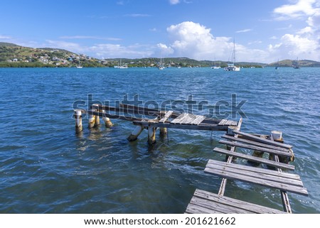 Broken dock extending into safe vessel harbor of Ensenada Honda on the Caribbean island of Culebra in Puerto Rico