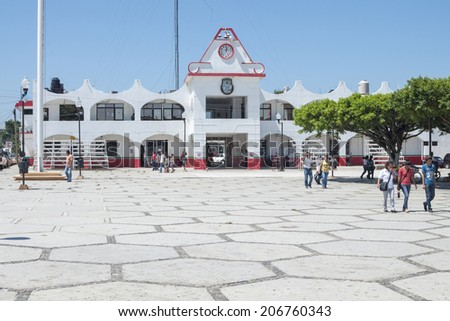 LAS CHOAPAS, MEXICO - JULY 17, 2014: In most Mexican cities the city hall faces the town plaza where people often visit after work to relax and meet friends.