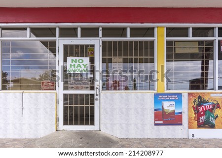 AGUADILLA, PUERTO RICO, USA - JANUARY 17, 2014: A convenient store in Aguadilla, Puerto Rico with sign informing customers they are out of gasolina, a popular alcoholic beverage in Puerto Rico.