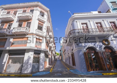 SAN JUAN, PUERTO RICO - JANUARY 29, 2014: Narrow brick streets and colonial-style architecture like these buildings on Calle San Francisco and Calle O\'Donnell are found throughout Old San Juan
