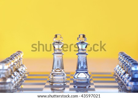 Two king chess pieces backed by their army