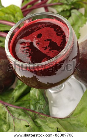 Glass of beet juice and fresh beets