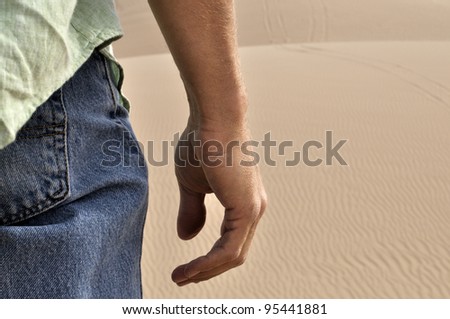Closeup of back of man standing in desert