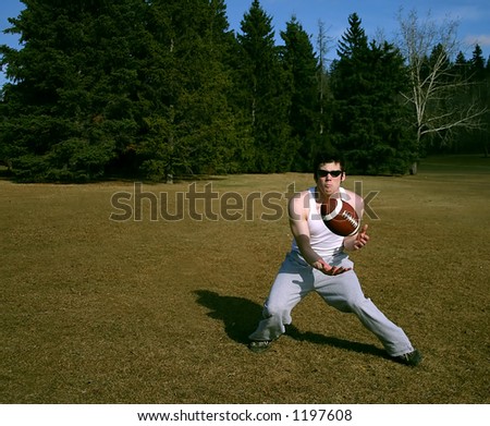 Guy catching a football that was thrown to him