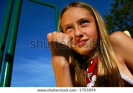 Young girl at park shaking fist