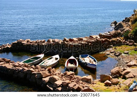 Close up of Fishing boats docked in a stone harbor at Taquile Island on Lake Titicaca in Peru