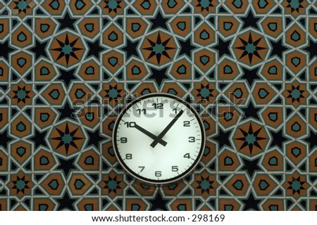 Clock on a patterned tile wall