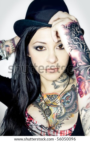 stock photo : Portrait of a young adult female with fashion hat and tattoos 