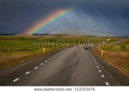 Rainbow appeared in the middle of storm above Icelandic road