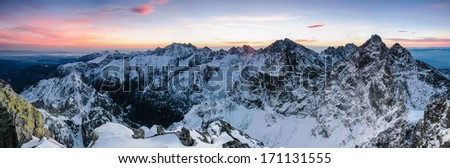 Scenic morning panorama of High Tatras mountain ridge covered by snow and ice with sunrise colours, Slovakia