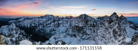 Scenic morning panorama of High Tatras mountain ridge with rugged peaks, covered by snow and ice with sunrise colours, Slovakia