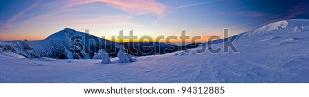 Morning panorama of Krkonose mountains with Snezka, national park at dawn in winter