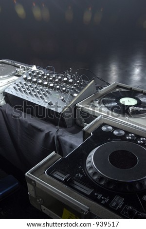Turntables, mixer and CD decks on a stage in a music venue