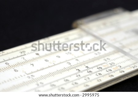 A slide rule from the sixties on a diagonal in shallow focus against black