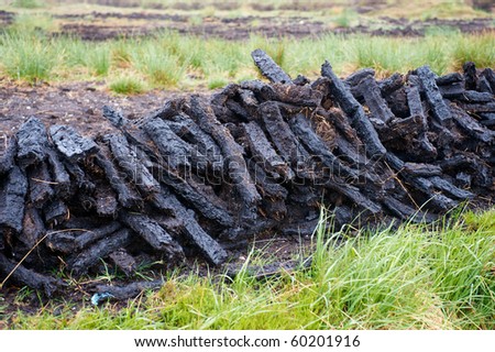 Thin blocks of cut peat dries in piles in wet upland rural Ireland