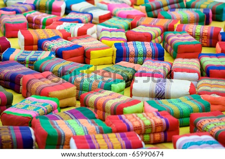 Colorful monk\'s prayer or meditation cushions scattered in the courtyard of Wat Pho temple in Bangkok