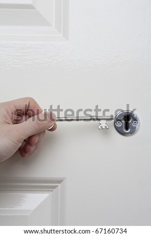 Key and Door. Male hand holding a door key