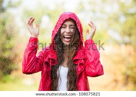 Woman in raincoat enjoying the rain