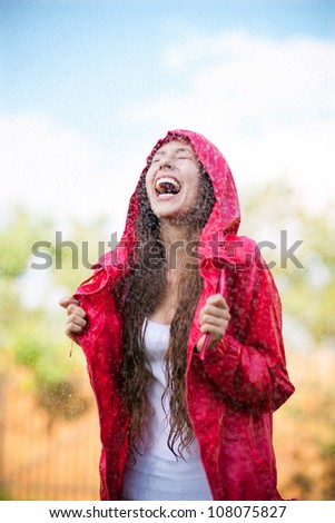 Woman in raincoat enjoying the rain