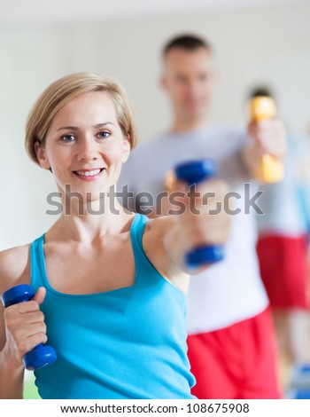 Couple working out with dumbbells