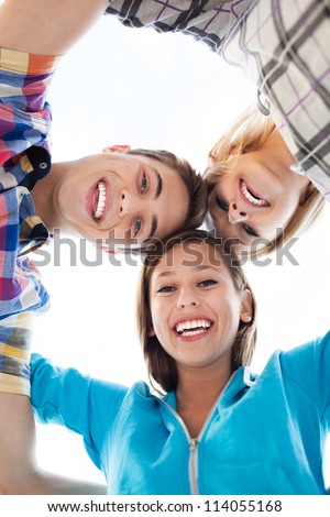 Three young people in a huddle