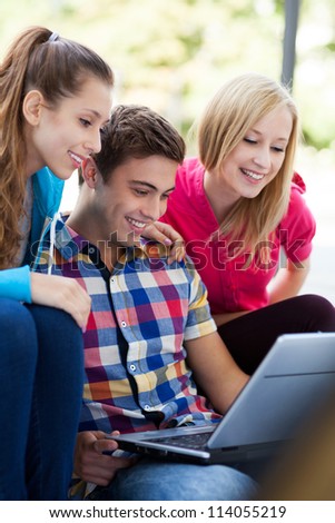 Friends looking at laptop together
