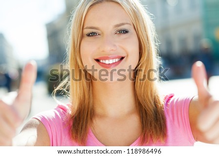 Attractive woman giving thumbs up