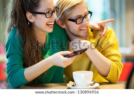 Young couple in cafe, laughing