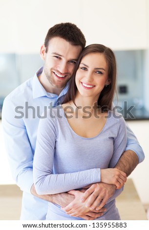 Young couple hugging at home