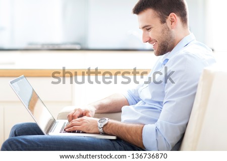 Man on sofa with laptop Man on sofa with laptop
