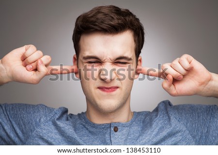 Man putting fingers in ears