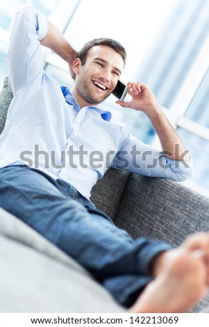 Man on sofa with mobile phone