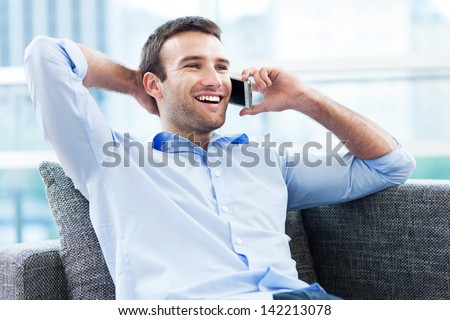 Man on sofa with mobile phone