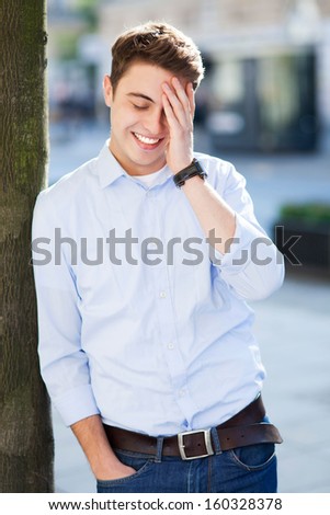 Man laughing, hand on forehead