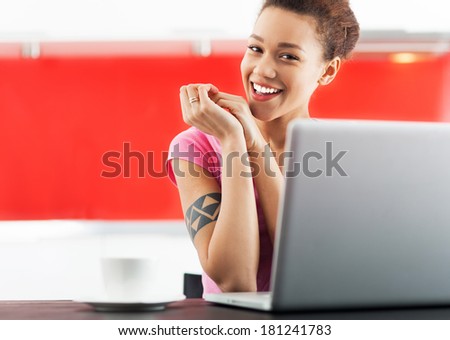 Smiling african american woman with laptop