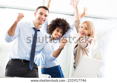 Business people cheering with arms raised