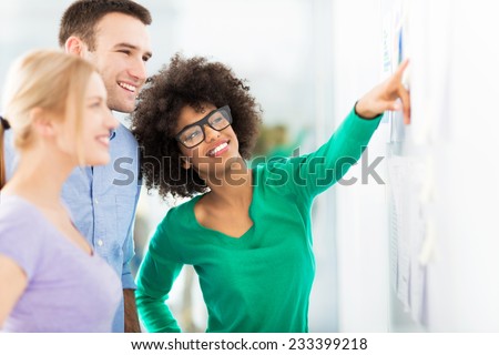 Young business people discussing on adhesive notes