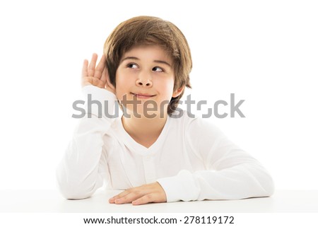 Boy with a hand to ear in a listening gesture