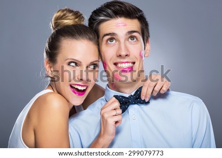 Man with lipstick marks and smiling woman