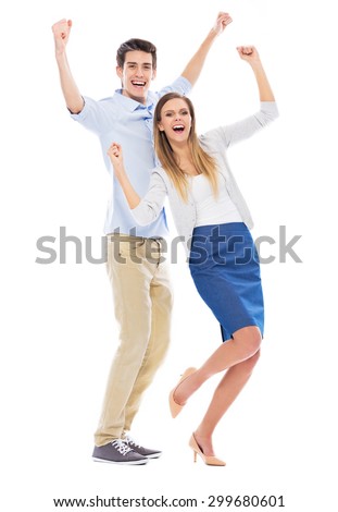 Young couple with arms raised