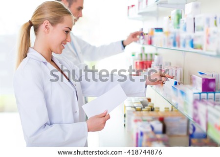 Female and male pharmacists in pharmacy