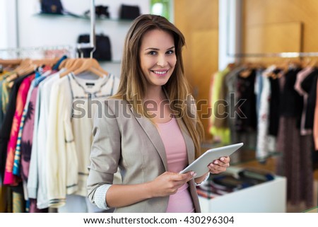 Boutique owner using a digital tablet