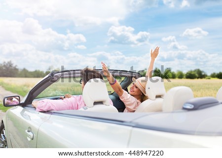Happy Couple Driving in Convertible