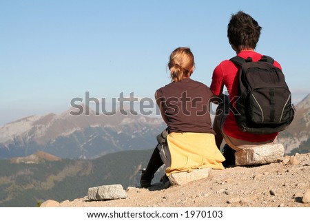 Couple Sitting and Looking Over Mountains