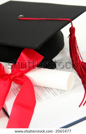 Graduation cap and diploma on a book