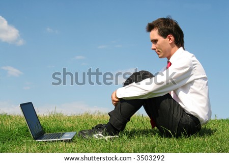 Man sitting outdoors with laptop
