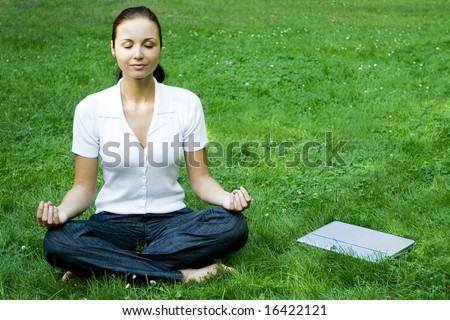 Meditating woman with laptop