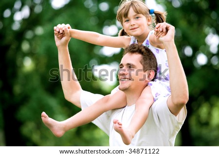 Father Giving Daughter Piggyback Ride